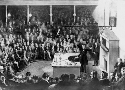 Faraday at the 1856 Christmas Lectures, one of his last. He gave 19 of them over his career—one of his earliest was on the chemistry of flame which he turned into The Chemical History of a Candle, a book for a non-expert reader.